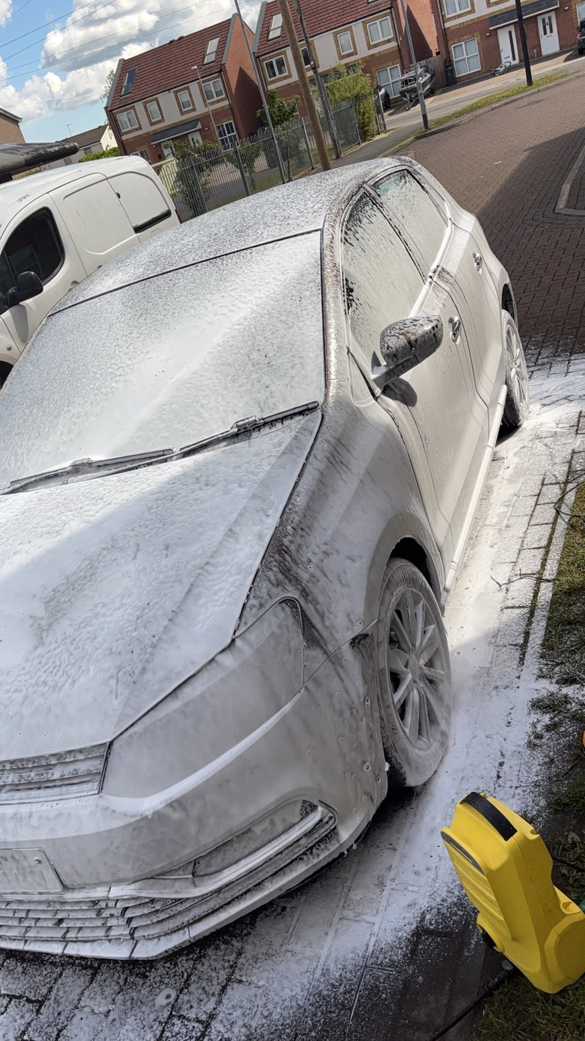 Snow foam pre-wash on a saloon car